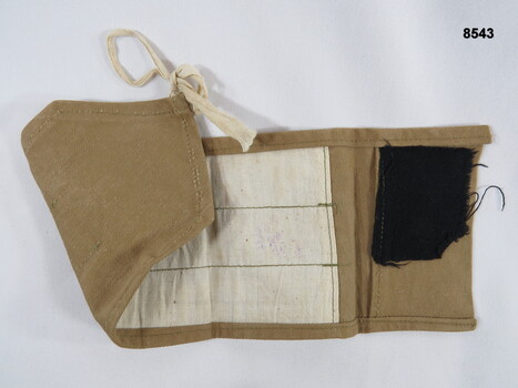 Khaki sewing kit with no contents.