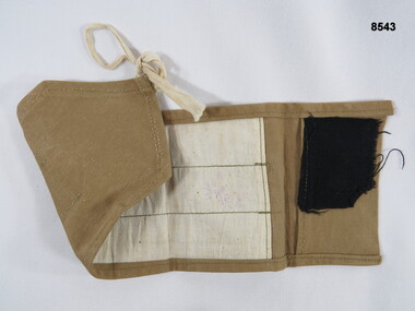 Khaki sewing kit with no contents.