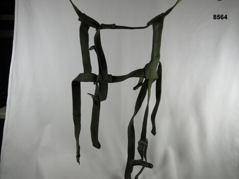 Army green, over the shoulder, webbing spider harness.