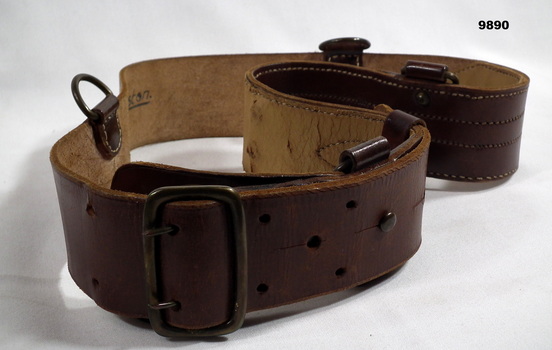 Brown leather belt with metal studs and clips.