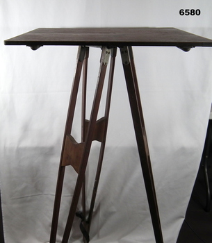A wooden Plane Table on wooden Tripod legs