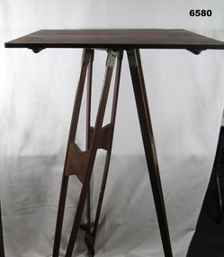 A wooden Plane Table on wooden Tripod legs