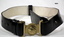 Black leather dress belt with brass buckle.