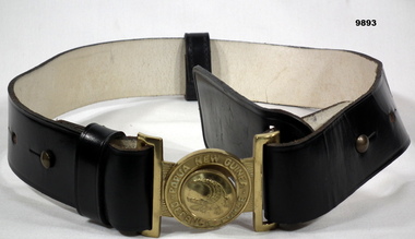 Black leather dress belt with brass buckle.