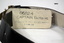 Black leather dress belt with brass buckle.