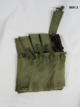Four pouch magazine holder Australian F1 9mm Sub Machine gun and one magazine.