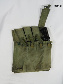 Four pouch magazine holder Australian F1 9mm Sub Machine gun and one magazine.