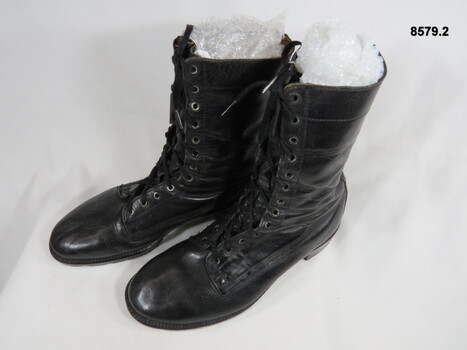 Black high sided army boots.