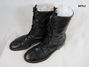 Black high sided army boots.