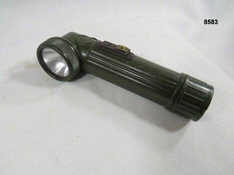 Hand held lamp with webbing attachments.