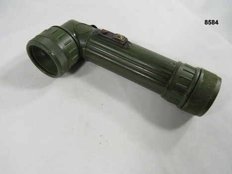 Hand held lamp with webbing attachment.