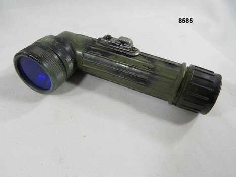 Hand held lamp with webbing attachment clip.