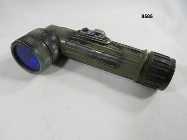 Hand held lamp with webbing attachment clip.