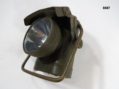 Hand held battery operated lamp with black out light cover.