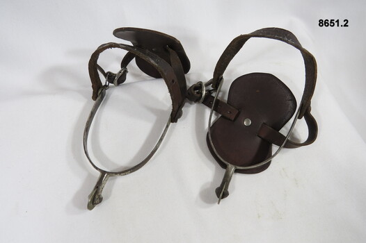 Riding spurs with leather adjustable boot straps.