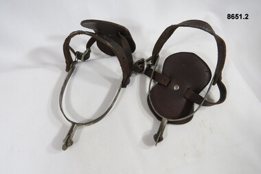 Riding spurs with leather adjustable boot straps.