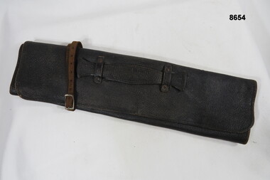 Leather document satchel with carry handle and closure strap.