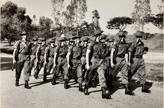 A Sgt leading a group in starched greens