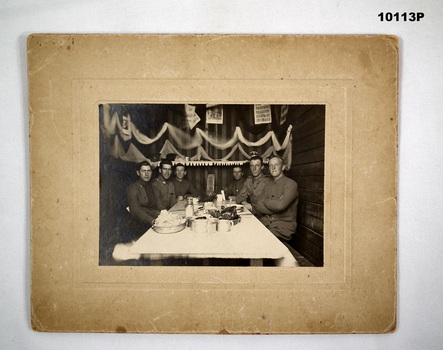 Group of six men at a table - black and white photograph.