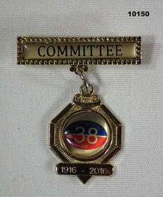 38th Battalion badge suspended on an inscribed bar.