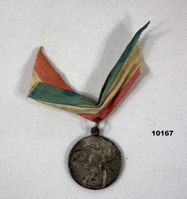Silver coloured medallion with red, white ad blue ribbon attached.