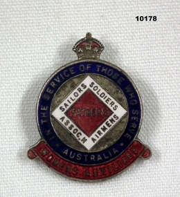Round metal and enamel badge with pin.