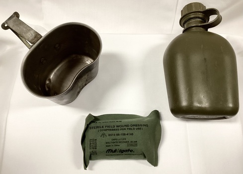 Water bottle, carrier, mug and field dressing.