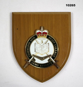 Shield shaped plaque with Command and Staff College insignia.