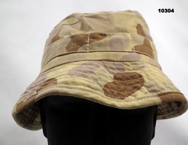Camouflage Army bush hat with narrow brim.