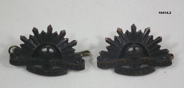 Two Rising Sun Lapel badges.
