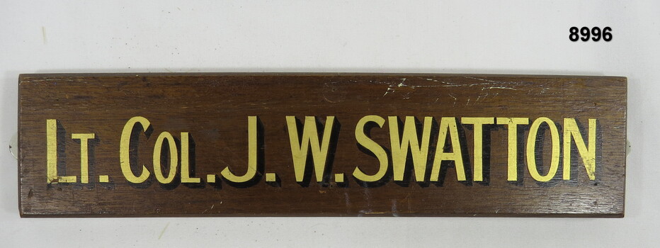 Rank and Name on wooden backboard.