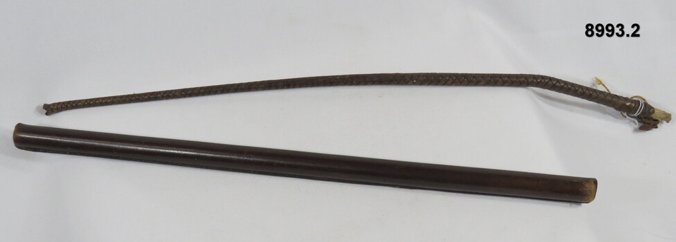 Leather baton and leather riding crop.