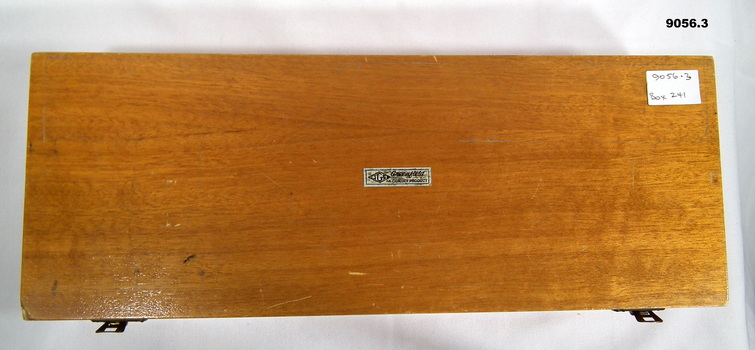 Wooden box containing plastic railway curves