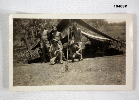 Photograph of five soldiers in front of a tent.