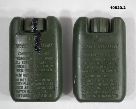 Two green tins of mosquito repellant.