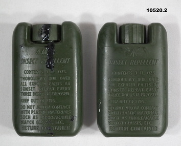 Two green tins of mosquito repellant.