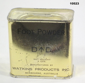 Gold coloured tin of foot powder.
