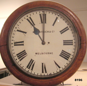Round Timber framed wind up clock.