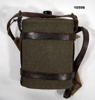Water bottle with green cloth cover and carry strap.