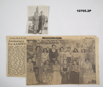 Newspaper article and accompanying black and white photograph.