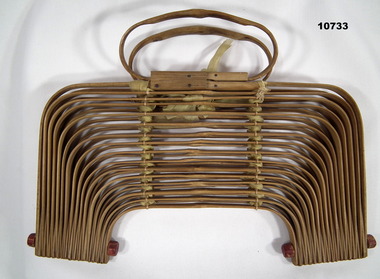 Folding bamboo basket with handles.