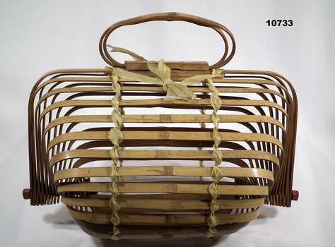 Folding bamboo basket with handles.