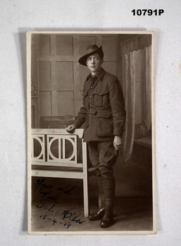 Photographic postcard featuring a WW1 soldier in uniform.