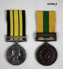 Two British Service medals with ribbons.