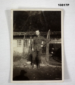 Photograph of an Australian WW1 soldier standing in front of a building.