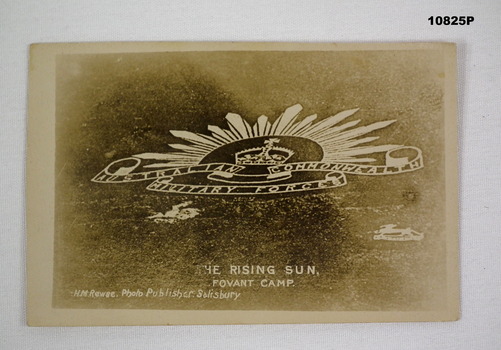 Photograph of a Rising Sun Badge cut into chalk on a hillside.