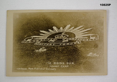 Photograph of a Rising Sun Badge cut into chalk on a hillside.
