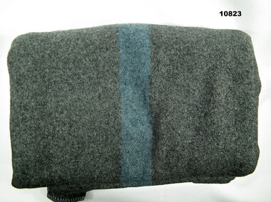 Grey Army blanket with blue stripes.