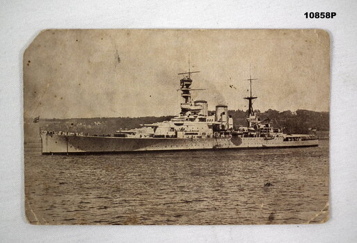 Photographic postcard featuring H.M.S. Renown at anchor.