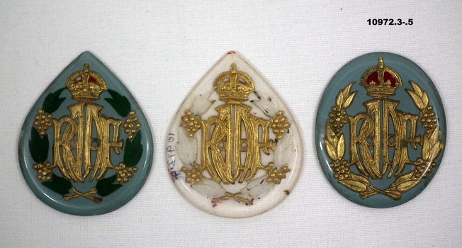 Collection of partially and fully completed badges and brooches.